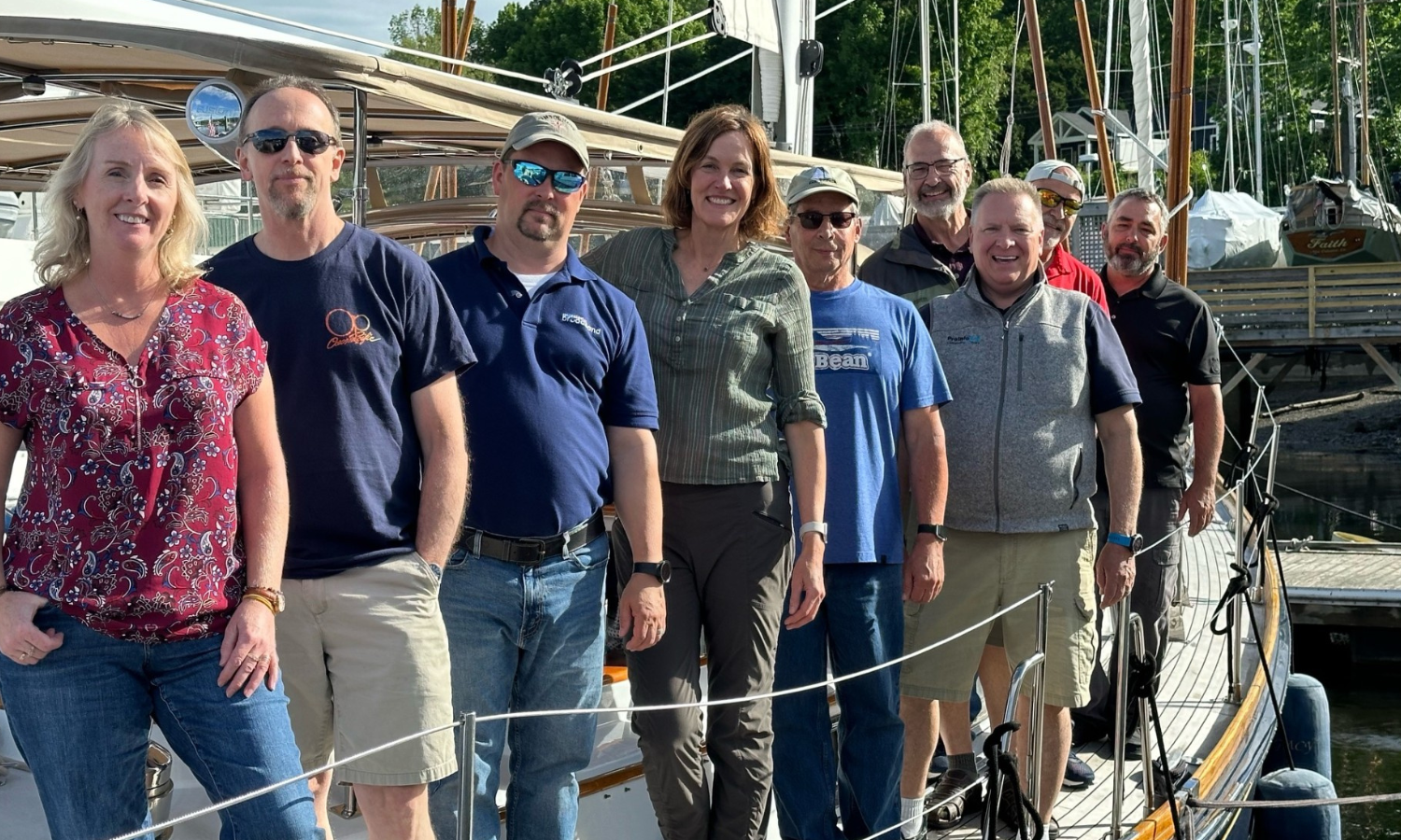 ProInfoNet's broadband team on the bow of a boat during a team sailing retreat.